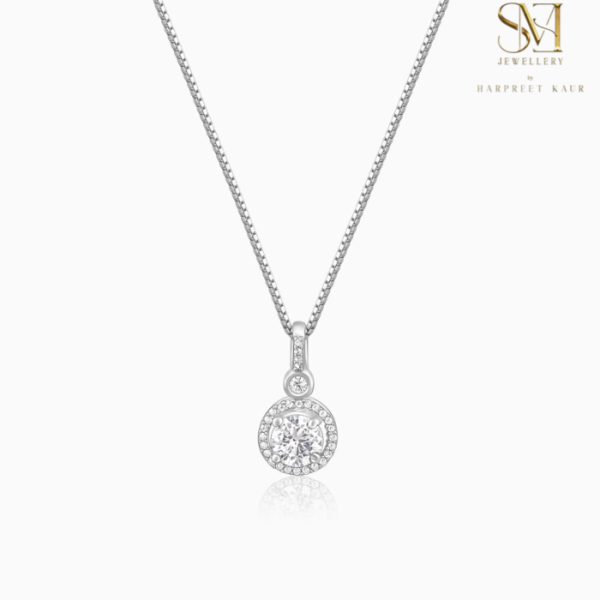 A silver pendant with a shimmering stone at its heart.