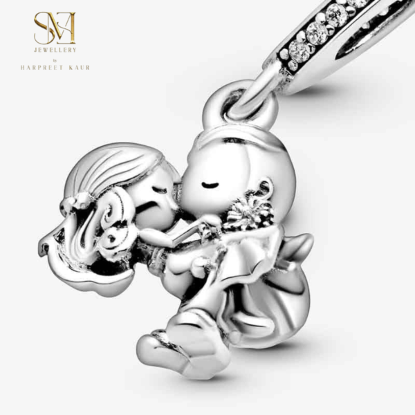 Celebrate love with our exquisite silver charm featuring a boy and girl sharing a sweet kiss—perfect for any romantic occasion.